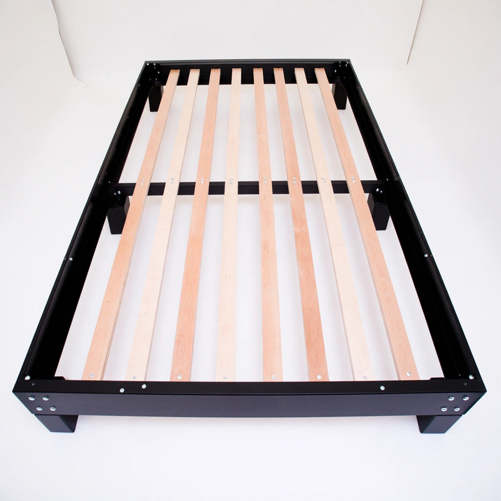 White wooden bedframe by Bistroandbreeze with a low-profile design, shown on a plain white studio background.