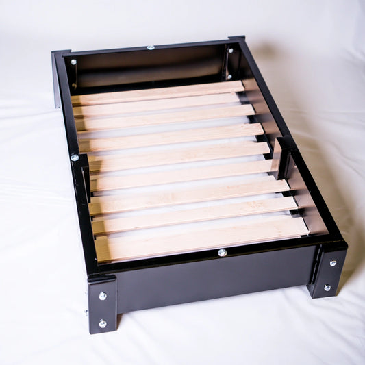 White wooden bedframe from Bistroandbreeze, low-profile metal and wood bed base on a plain white background.